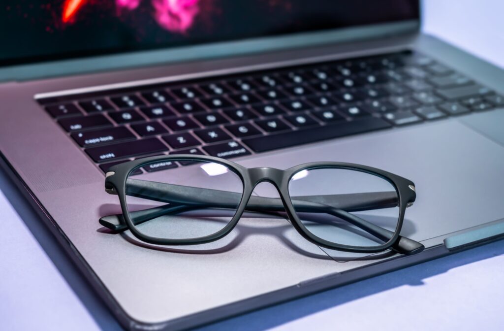 Blue light blocking glasses sitting on a laptop.