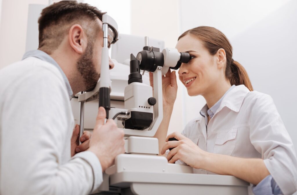 A patient having their eyes examined by an optometrist during a comprehensive eye exam.