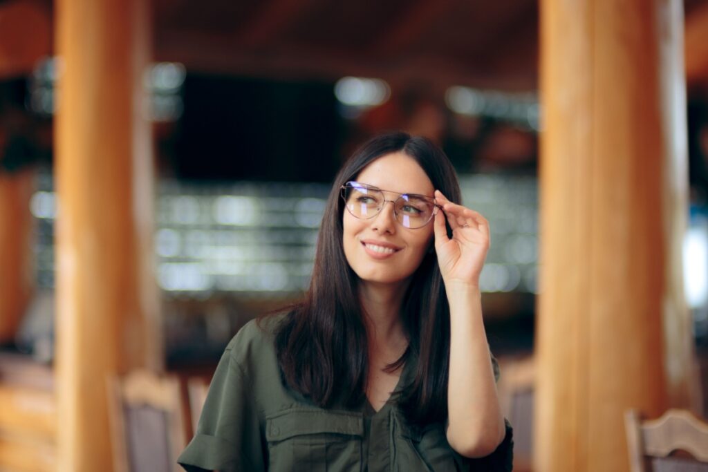 A person wearing glasses with anti-reflective coating.