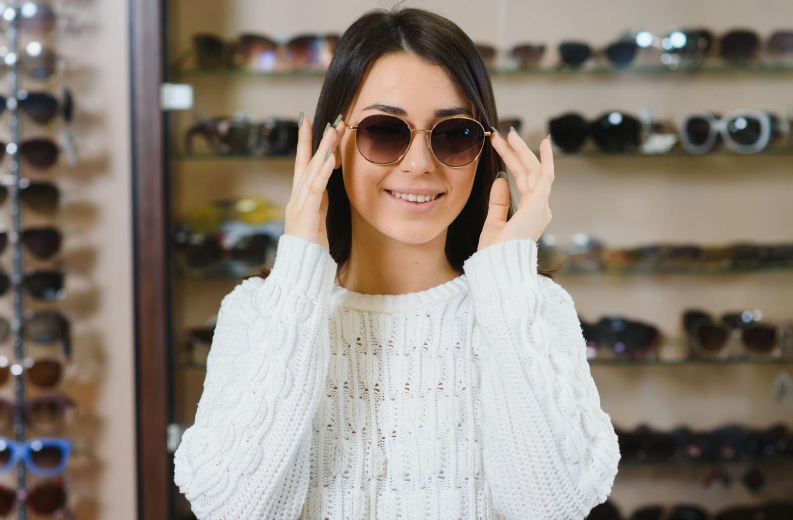 A person trying on a pair of polarized sunglasses at their optometrist's office.